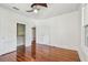 Inviting bedroom with hardwood floors, ceiling fan, and ample closet space at 506 S Melville Ave, Tampa, FL 33606