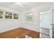 Bright bedroom featuring wood floors, an open doorway, and ample natural light at 506 S Melville Ave, Tampa, FL 33606