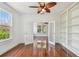 Charming room with hardwood floors, bookshelves, and view to the backyard at 506 S Melville Ave, Tampa, FL 33606