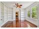 Versatile room featuring hardwood floors, built-in shelving, and natural light at 506 S Melville Ave, Tampa, FL 33606