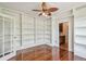 Bright room with hardwood floors, bookshelves, and view to another room at 506 S Melville Ave, Tampa, FL 33606