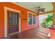 Inviting front porch with ceiling fan, wood floors, and craftsman style door at 506 S Melville Ave, Tampa, FL 33606
