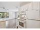 The kitchen features white cabinets and modern appliances at 506 S Melville Ave, Tampa, FL 33606