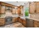 Bright kitchen features stainless appliances, wood cabinets, and granite countertops at 506 S Melville Ave, Tampa, FL 33606