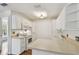 Bright kitchen featuring white cabinets, a white countertop, and essential appliances at 506 S Melville Ave, Tampa, FL 33606