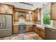 Bright kitchen with wood cabinets, stainless appliances and a farmhouse sink at 506 S Melville Ave, Tampa, FL 33606