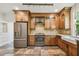 Bright kitchen with stainless steel appliances, wood cabinets, and farmhouse sink at 506 S Melville Ave, Tampa, FL 33606