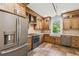 This kitchen features stainless steel appliances, wood cabinets and a farmhouse sink at 506 S Melville Ave, Tampa, FL 33606