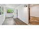Bright laundry room with stacked washer and dryer, window, and wood-look flooring at 506 S Melville Ave, Tampa, FL 33606