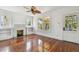 Cozy living room featuring hardwood floors, fireplace, and large windows at 506 S Melville Ave, Tampa, FL 33606