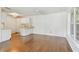 Living room and kitchen area with hardwood floors and white cabinets at 506 S Melville Ave, Tampa, FL 33606