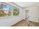 Bright living space with wood-look floors and an abundance of natural light from the yard at 506 S Melville Ave, Tampa, FL 33606