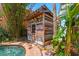 Charming pool house nestled amongst lush tropical foliage and a sparkling pool at 506 S Melville Ave, Tampa, FL 33606