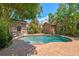 Secluded backyard showcasing a freeform pool, lush landscaping, and a decorative shed at 506 S Melville Ave, Tampa, FL 33606