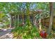 Screened-in porch surrounded by lush, tropical landscaping at 506 S Melville Ave, Tampa, FL 33606