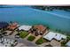 Aerial view of waterfront home with a private dock, pool, and lush landscaping at 514 Harbor N Dr, Indian Rocks Beach, FL 33785