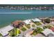 Aerial view of waterfront property with lush landscaping, boat dock, and waterway access at 514 Harbor N Dr, Indian Rocks Beach, FL 33785