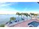 Backyard showing pool, boat lift, dock and palms; perfect for enjoying waterfront living at 514 Harbor N Dr, Indian Rocks Beach, FL 33785