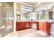 Spacious bathroom featuring dual vanities, large mirrors, and a glass-enclosed shower at 514 Harbor N Dr, Indian Rocks Beach, FL 33785