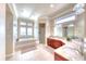 Bright bathroom boasts a soaking tub, walk-in shower, and double vanity with marble countertops at 514 Harbor N Dr, Indian Rocks Beach, FL 33785