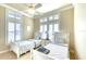 Cozy bedroom with twin beds, bright windows, and neutral tones, perfect for Gathering or guests at 514 Harbor N Dr, Indian Rocks Beach, FL 33785