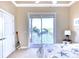 Bedroom with sliding glass doors, providing stunning water views and access to a private balcony at 514 Harbor N Dr, Indian Rocks Beach, FL 33785