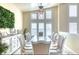 Elegant dining room with a large table, decorative wall art, and bright, sunny exposure at 514 Harbor N Dr, Indian Rocks Beach, FL 33785