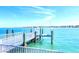 Private boat dock with clear water, offering direct access to the bay and waterfront activities at 514 Harbor N Dr, Indian Rocks Beach, FL 33785