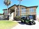 Beautiful two-story home with a grand staircase, lush landscaping, and convenient golf cart parking at 514 Harbor N Dr, Indian Rocks Beach, FL 33785