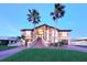Stunning two-story home featuring a brick stairway, lush lawn, and beautiful palm trees at 514 Harbor N Dr, Indian Rocks Beach, FL 33785