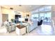 Bright living room showcasing tile floors, comfortable seating, fireplace, and access to a large patio at 514 Harbor N Dr, Indian Rocks Beach, FL 33785