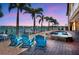Backyard pool and waterfront patio features lounge chairs and access to private dock at 514 Harbor N Dr, Indian Rocks Beach, FL 33785