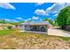 Back of home featuring a screened in porch area and well-maintained lawn at 521 E Lumsden Rd, Brandon, FL 33511