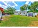 Home's backyard featuring two storage sheds, screened-in porch and green grass at 521 E Lumsden Rd, Brandon, FL 33511
