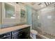 Updated bathroom featuring a vanity with marble countertop and a tiled walk-in shower with a glass door at 521 E Lumsden Rd, Brandon, FL 33511
