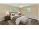 Cozy bedroom with a ceiling fan, two windows, neutral walls, and a comfortable queen-sized bed with nightstands at 521 E Lumsden Rd, Brandon, FL 33511