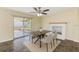 Dining area features sliding glass doors to the patio, contemporary lighting and a brick fireplace at 521 E Lumsden Rd, Brandon, FL 33511