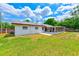 Home's exterior showing the screened-in porch, lawn and the side of the house at 521 E Lumsden Rd, Brandon, FL 33511