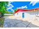 Home's exterior featuring a blue door, patio, concrete and partial fence at 521 E Lumsden Rd, Brandon, FL 33511