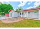 Charming brick home with a white front door, brick walkway, front garden, and a well-manicured lawn at 521 E Lumsden Rd, Brandon, FL 33511