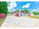 Charming single-story home featuring a red-trimmed roof, brick facade, spacious driveway, and well-kept landscaping at 521 E Lumsden Rd, Brandon, FL 33511