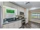 Bright kitchen with stainless steel appliances, stylish cabinetry, and granite countertops at 521 E Lumsden Rd, Brandon, FL 33511