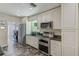 Beautiful kitchen with white cabinets, granite counters, stainless steel appliances and tile flooring at 521 E Lumsden Rd, Brandon, FL 33511