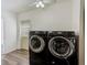 Laundry room featuring modern black front-load washer and dryer units at 521 E Lumsden Rd, Brandon, FL 33511
