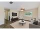 Bright and airy living room featuring a large window, neutral tones, and a comfortable seating arrangement at 521 E Lumsden Rd, Brandon, FL 33511