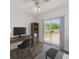 Office with desk, a large window that gives access to the backyard, and neutral-toned walls at 521 E Lumsden Rd, Brandon, FL 33511