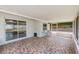Enclosed patio with colorful tile flooring, sliding glass doors, and a screened section at 521 E Lumsden Rd, Brandon, FL 33511