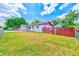 Well-maintained yard with vibrant green grass surrounding a charming single-story home with a red-trimmed roof at 521 E Lumsden Rd, Brandon, FL 33511