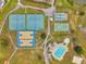 Aerial view of community amenities, including pools, tennis courts, and play area at 5306 Marlwood Ct, Tampa, FL 33624