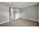 Neutral-toned bedroom with a view of the closet and an open doorway at 5306 Marlwood Ct, Tampa, FL 33624